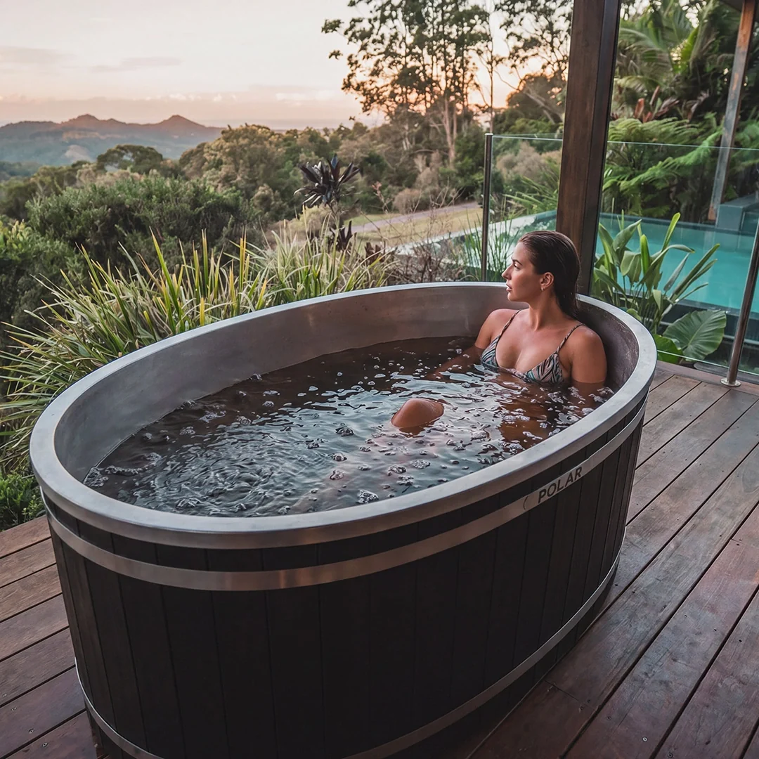 Woman sitting in an outdoor ice bath